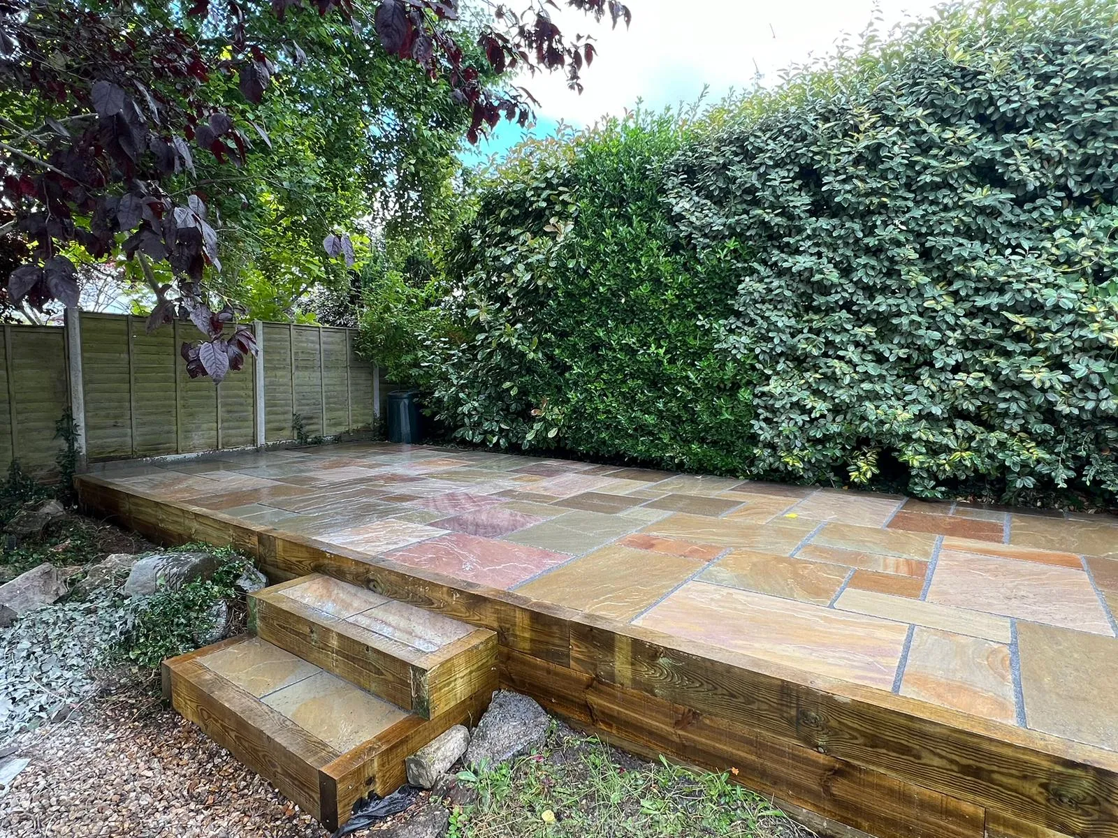A wooden deck with steps leading up to it.